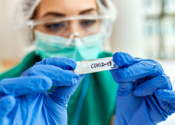 closeup-of-epidemiologist-with-covid19-sample-in-test-tube